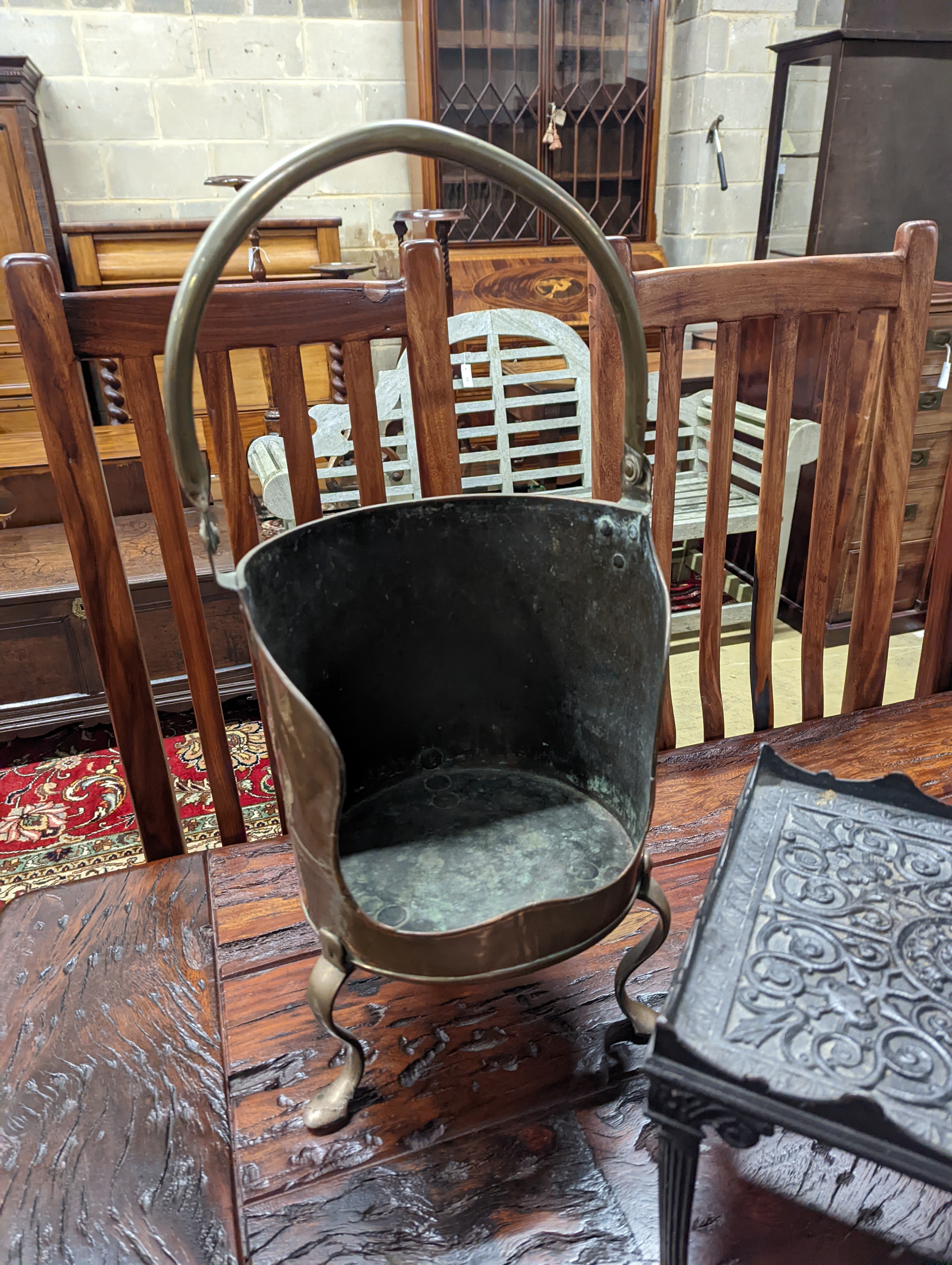 A Victorian copper coal scuttle, a square cast iron trivet, pewter items etc.